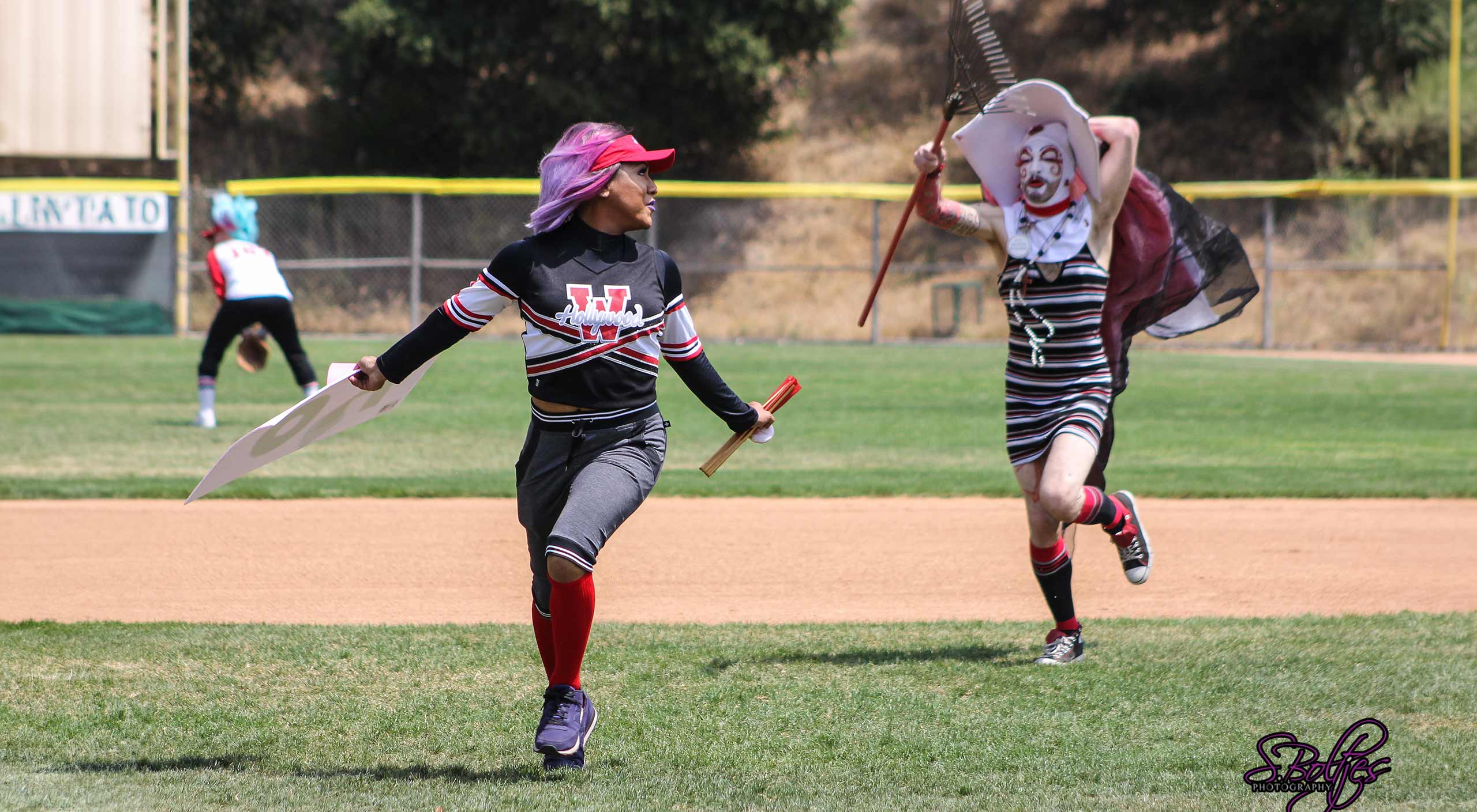 Drag Queens playing baseball running it the field
